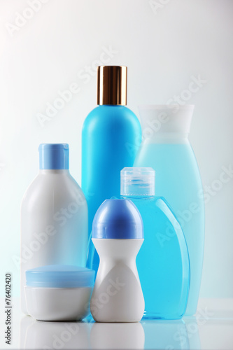 Cosmetic bottles on light background
