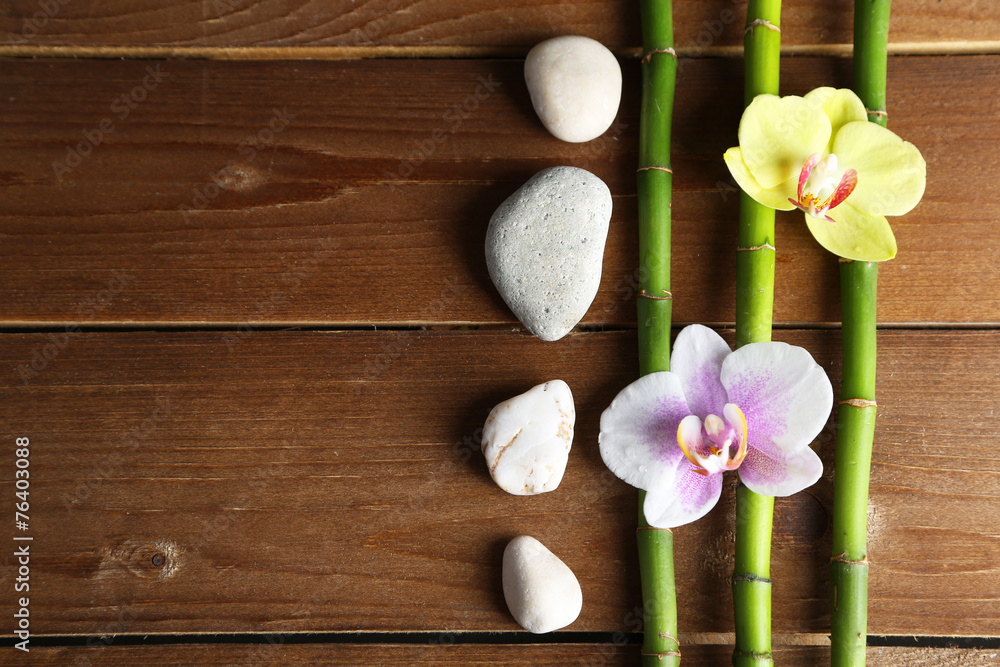 Orchid flowers and bamboo with pile stones on wooden Orchid flowers and bamboo with pile stones on wooden