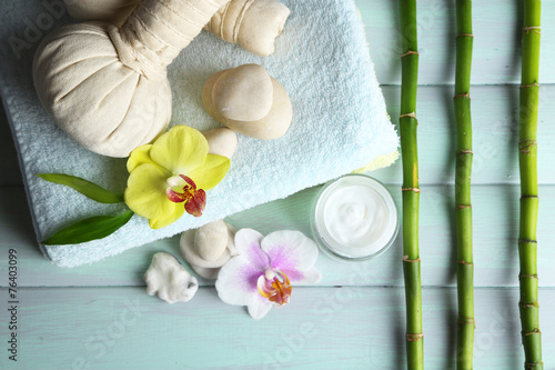 Spa treatments with orchid flowers on wooden table background