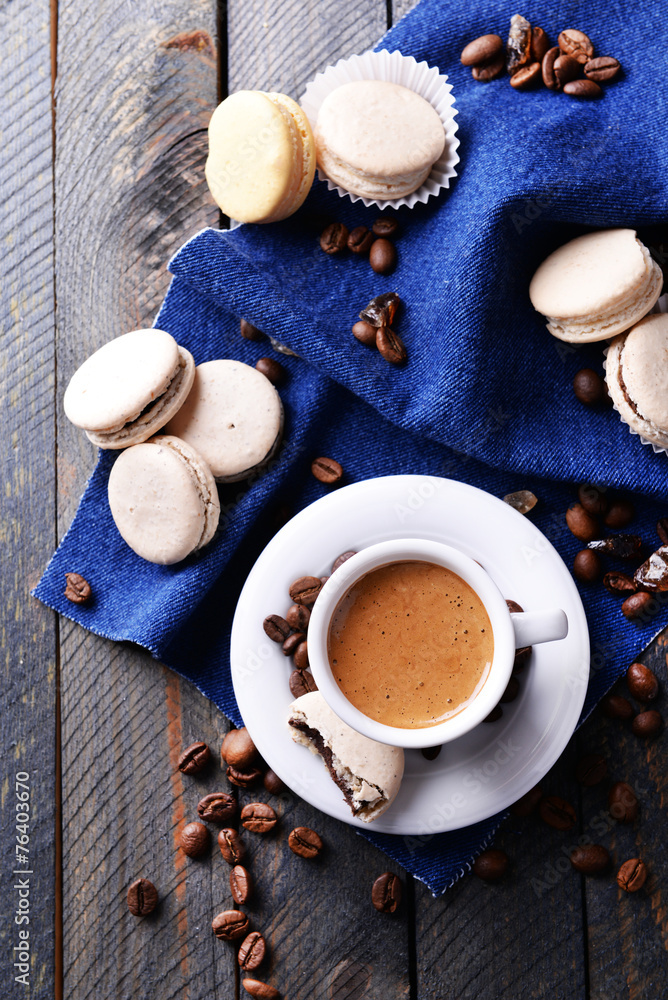 Gentle colorful macaroons and coffee in mug Gentle colorful macaroons and coffee in mug