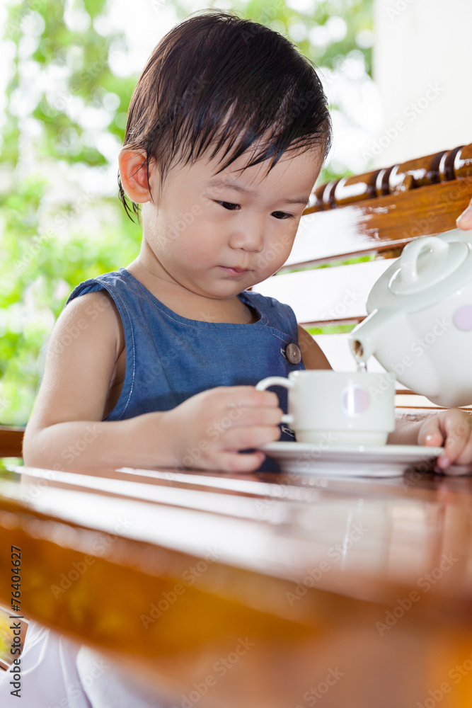 Little asian girl (thai) holding a cup Little asian girl (thai) holding a cup