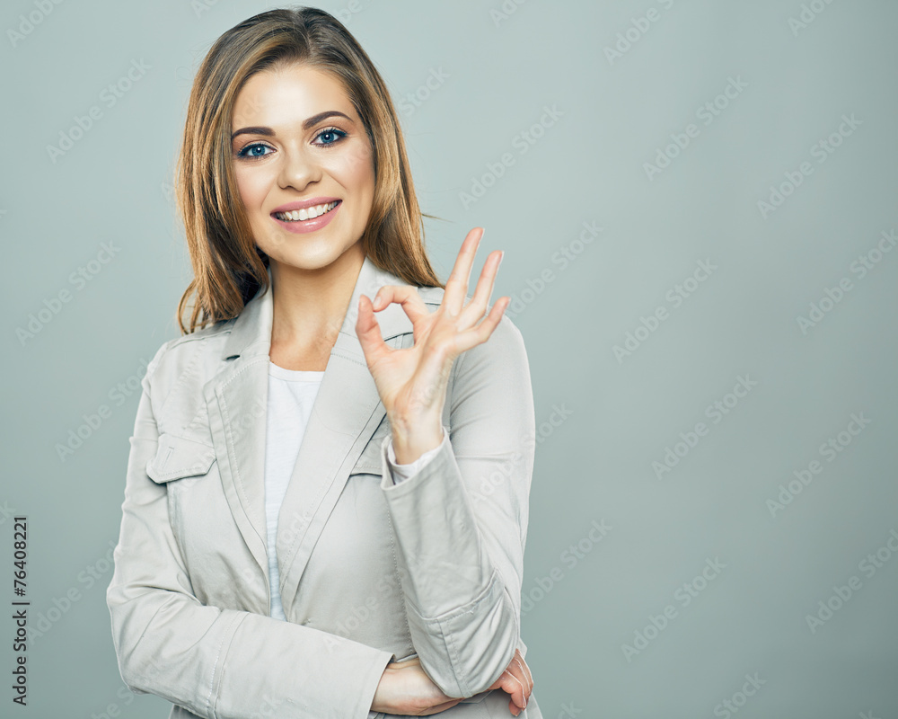 Business woman show ok symbol. Toothy smiling business woman Business woman show ok symbol. Toothy smiling business woman