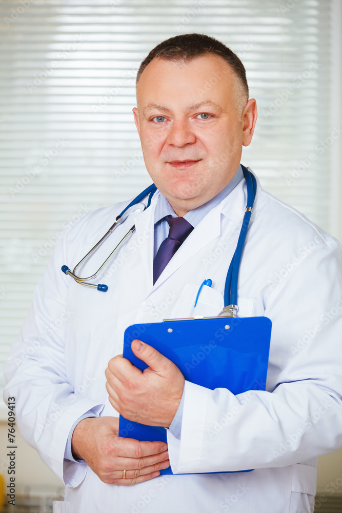 Portrait of Doctor with stethoscope looking at the camera. Portrait of Doctor with stethoscope looking at the camera.