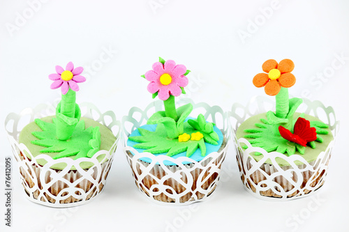 sweet spring flowers muffin cakes on white