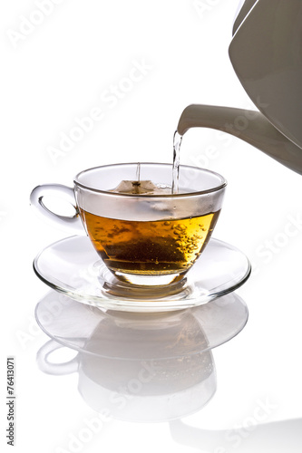 Tea being poured into glass tea cup