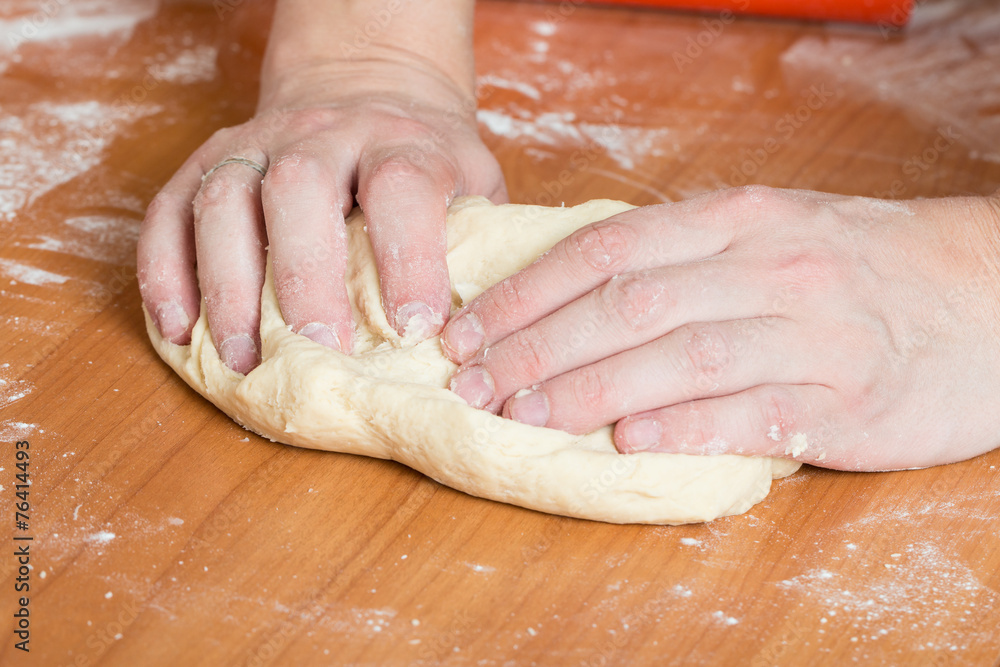 male hands kneading dough on table male hands kneading dough on table