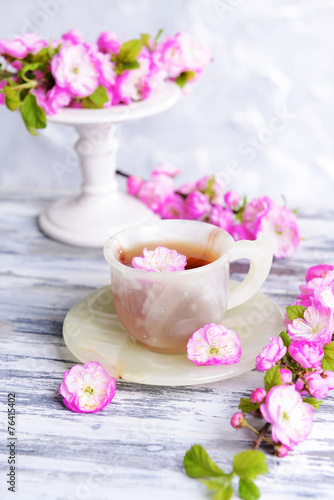 Beautiful fruit blossom with cup of tea
