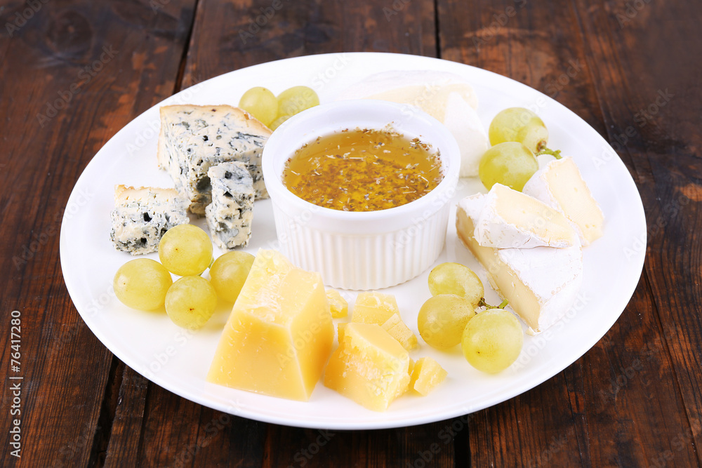 Different sort of cheese with grape and saucer Different sort of cheese with grape and saucer