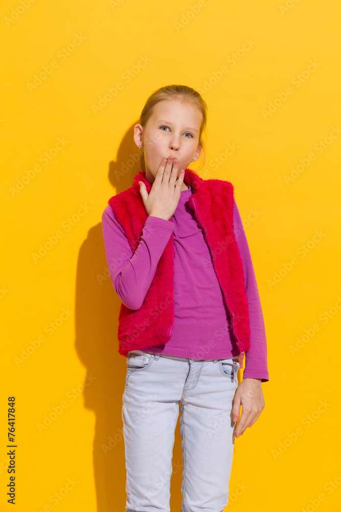 Oops! Young blond girl holding hand on her mouth. Oops! Young blond girl holding hand on her mouth.