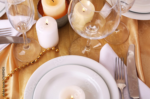 Beautiful holiday table setting in white and gold color