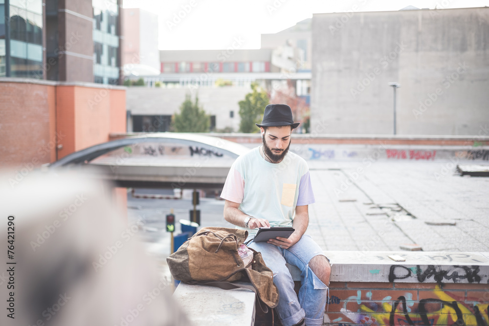 young handsome hipster gay modern man using tablet young handsome hipster gay modern man using tablet