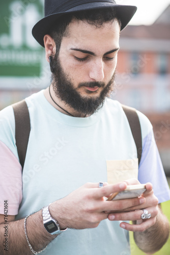 young handsome hipster gay modern man using smartphone