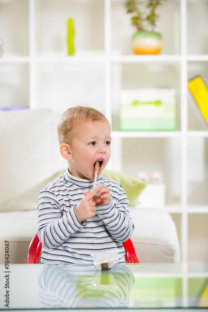 Two-years child himself eats with spoon Two-years child himself eats with spoon