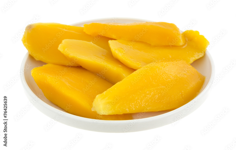 Mango slices in a small dish on a white background Mango slices in a small dish on a white background