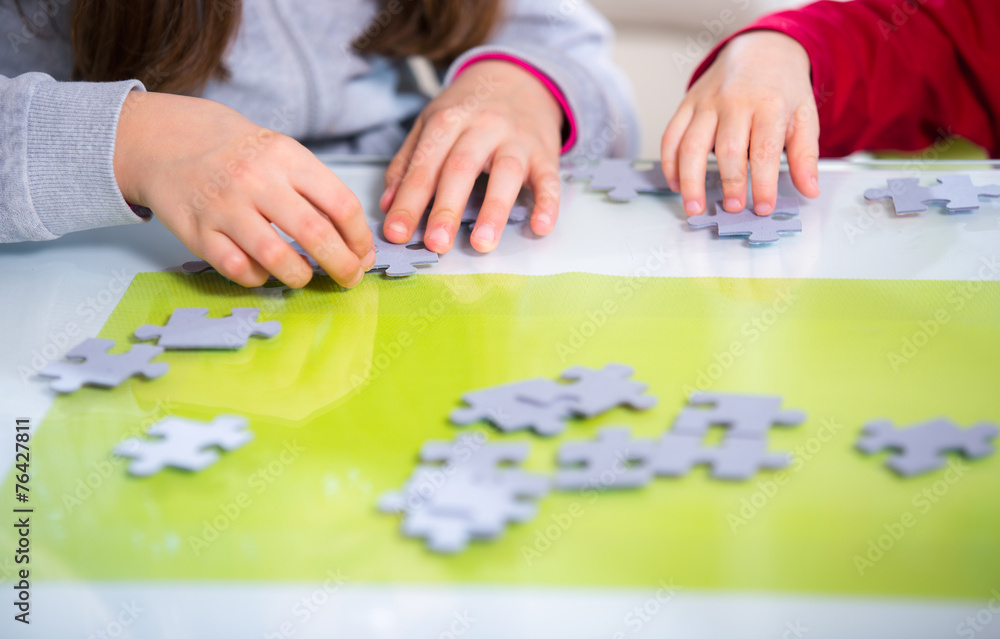 Two children playing with puzzles Two children playing with puzzles