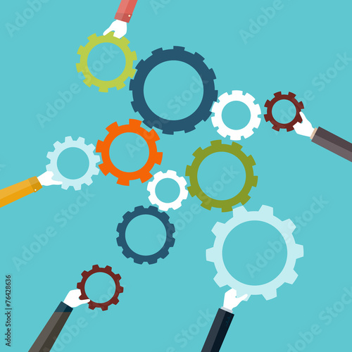 Concept of teamwork holding colorful cogwheel