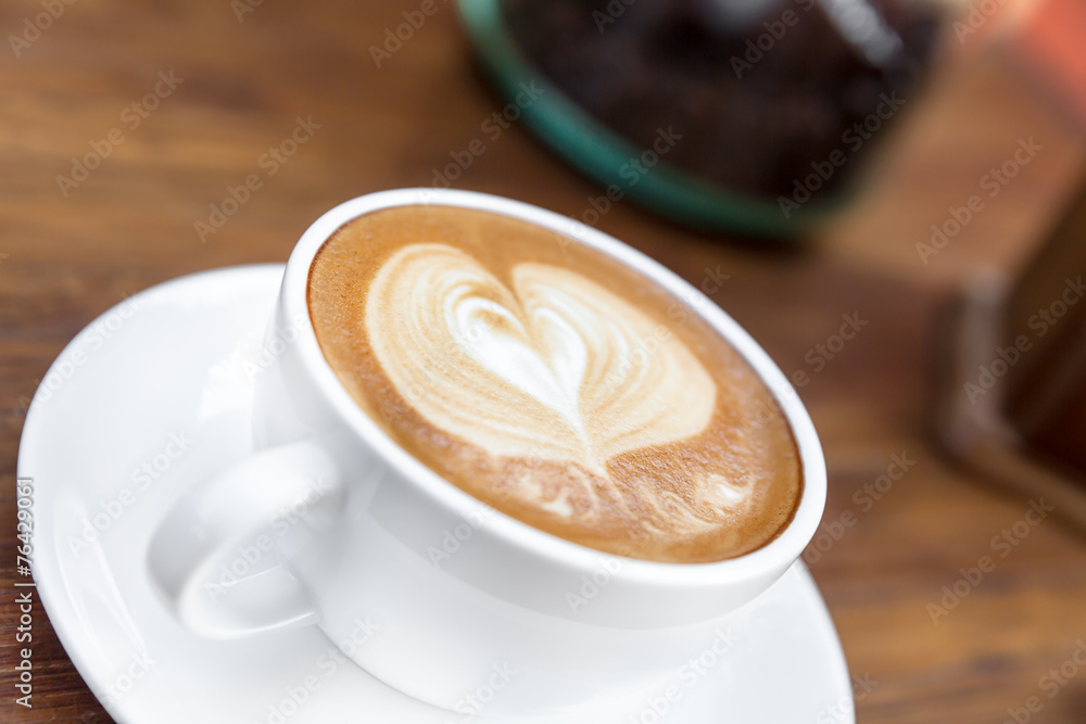 Latte art, coffee on the wooden desk as background Latte art, coffee on the wooden desk as background
