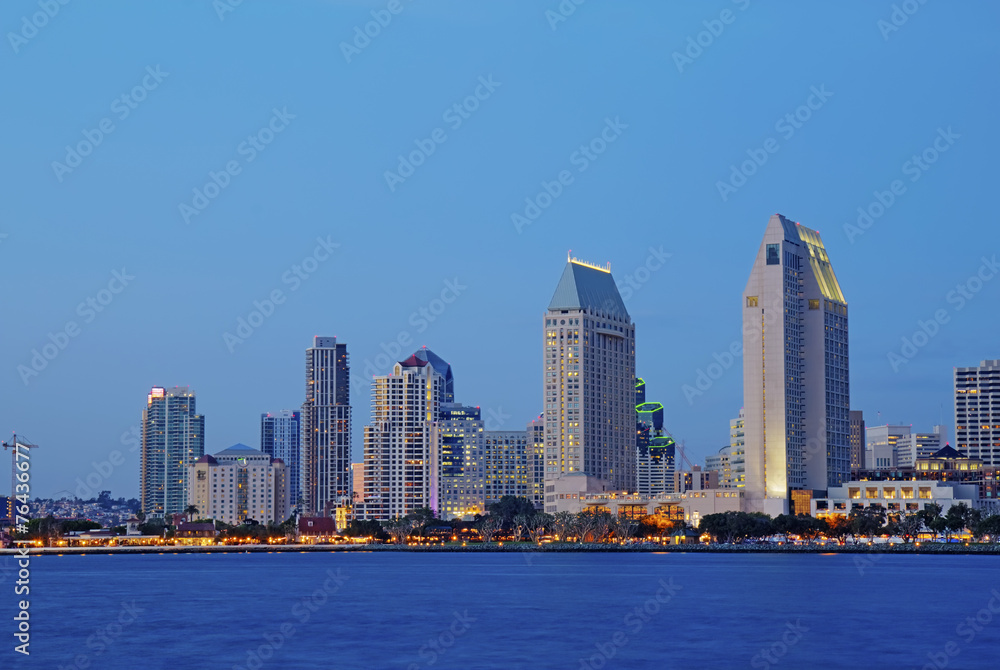 Partial skyline of San Diego over water at night