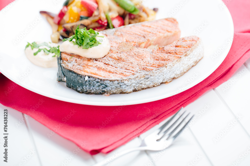 Grilled Salmon with Fresh vegetables on red background Grilled Salmon with Fresh vegetables on red background