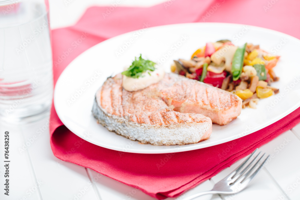 Grilled Salmon with Fresh vegetables on red background Grilled Salmon with Fresh vegetables on red background