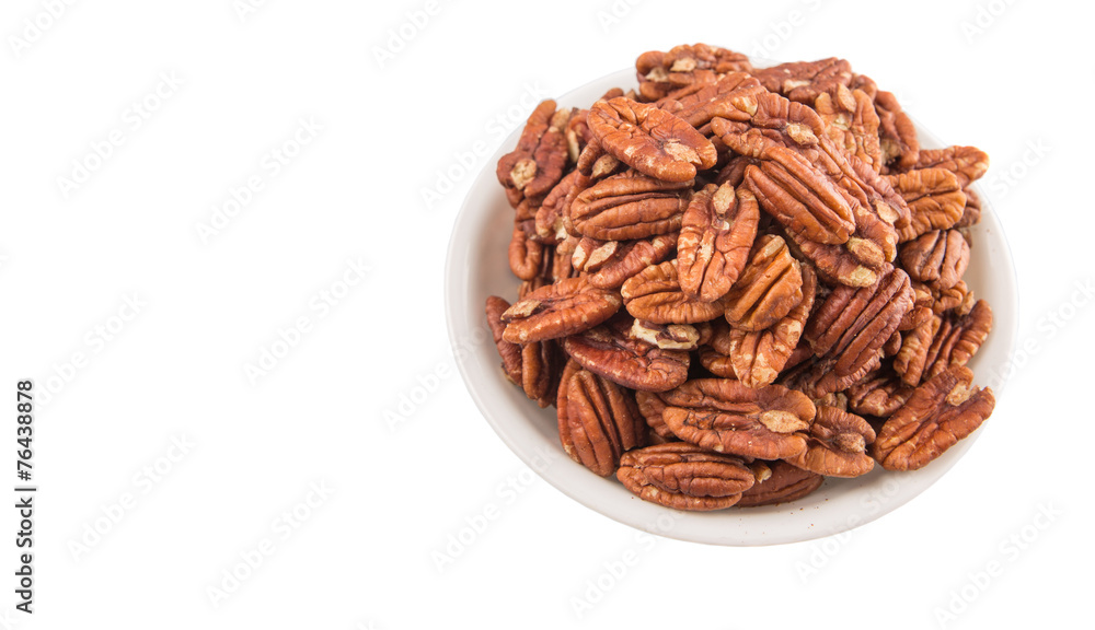 Pecan nut in a white bowl over white background Pecan nut in a white bowl over white background