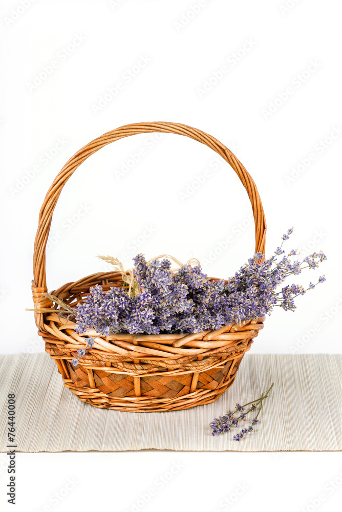Basket with dry lavender flowers isolated on white Basket with dry lavender flowers isolated on white