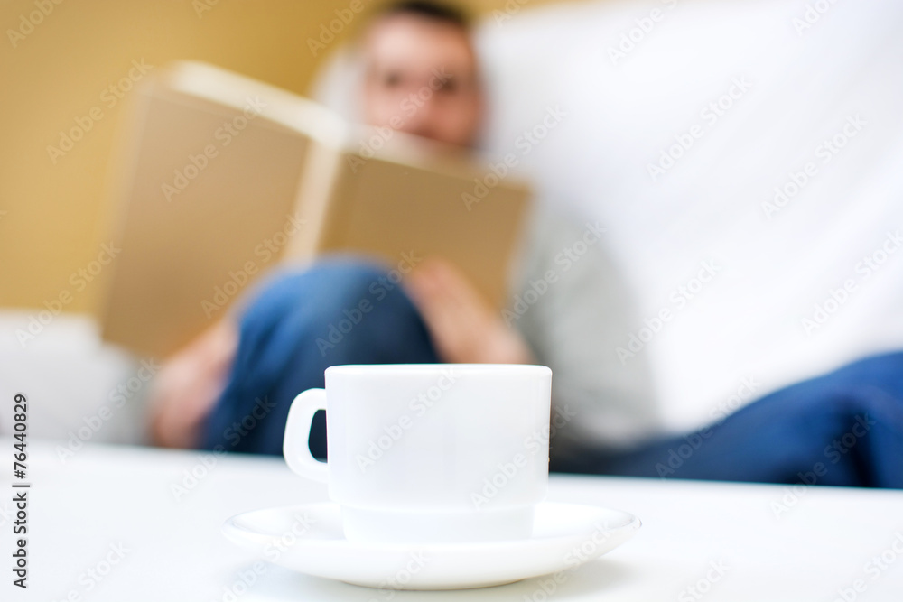 Young man reading on the sofa for your home Young man reading on the sofa for your home