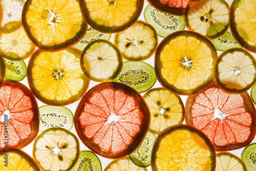 Fotografie Transparency sliced fruits on white background