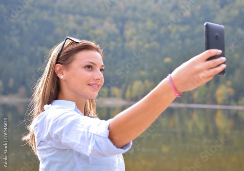 Young girl tourist takes selfie