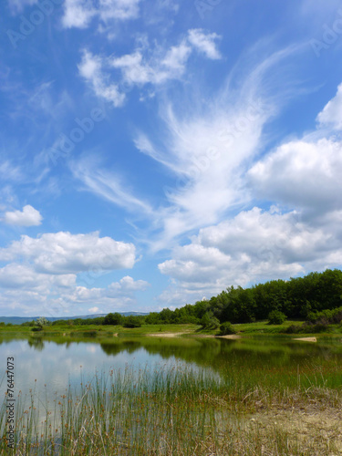 Day landscape with different clouds in the blue sky © alexaphotoua