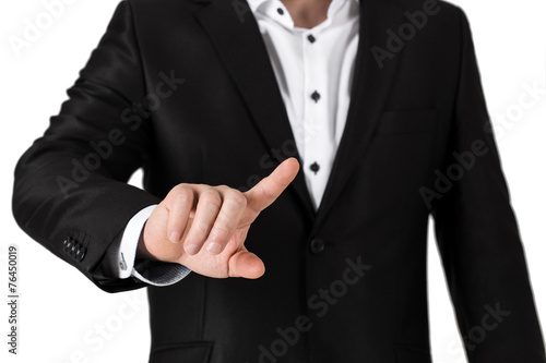 Business man in suit pressing on blank button. Isolated on white