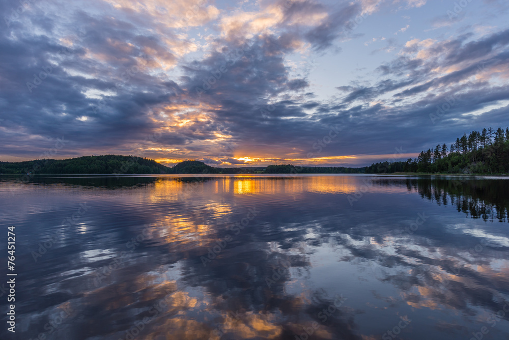 Orange sunset on Lake Ladoga. Reflection.