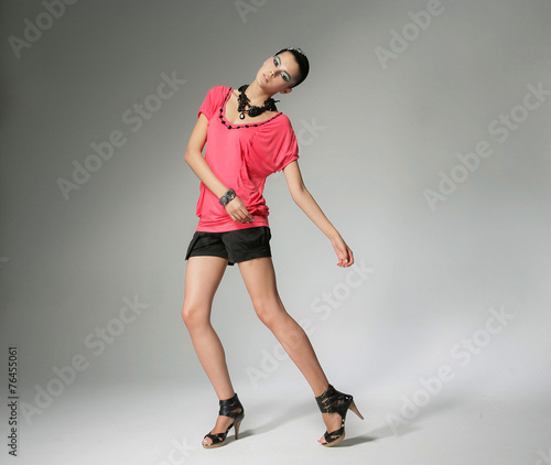 full-length fashion shot of girl with posing in light background 