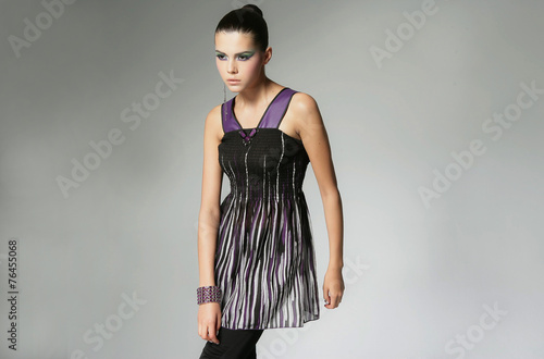 portrait of a styled professional model in black dress posing 
