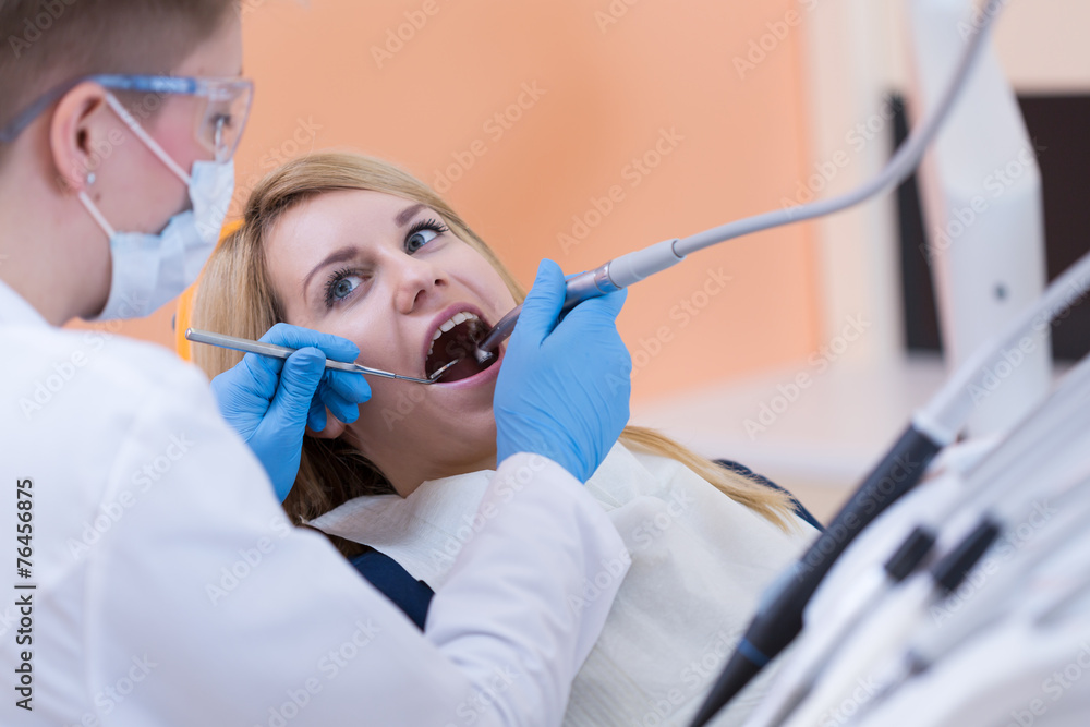 Dentist drilling a tooth Dentist drilling a tooth