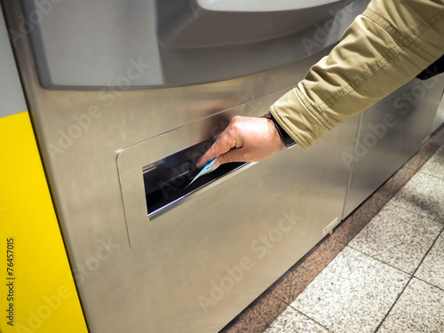 hand with ticket on a vending machine