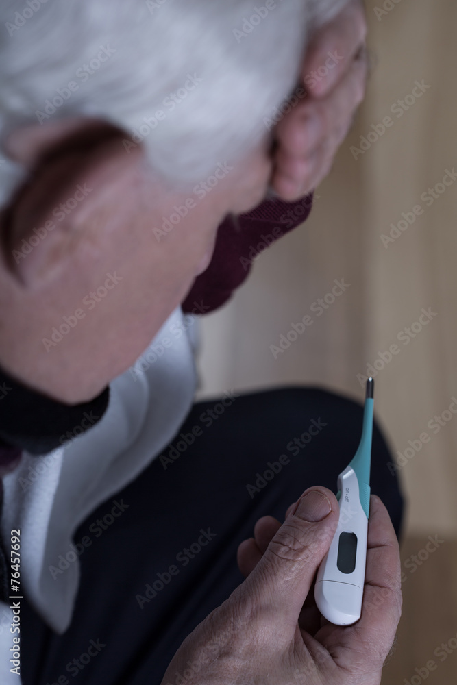 Fotografie Close-up of man taking temperature