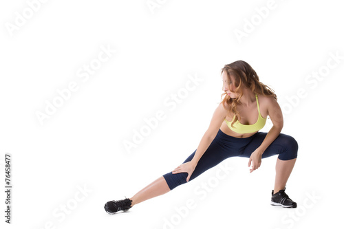 Pretty girl doing stretching, isolated on white