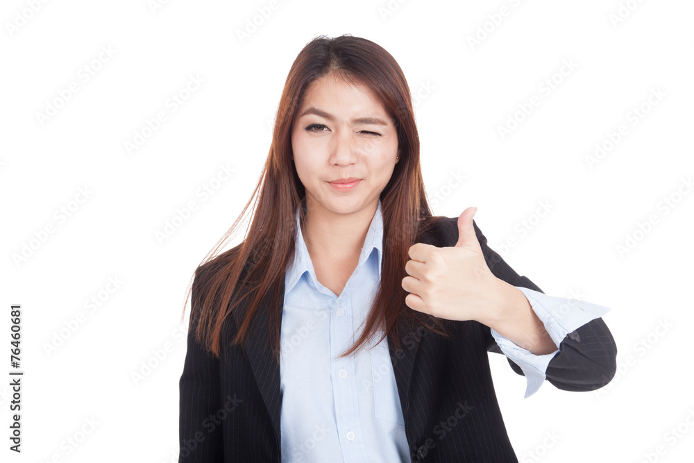 Young Asian businesswoman winks her eye and thumbs up Young Asian businesswoman winks her eye and thumbs up