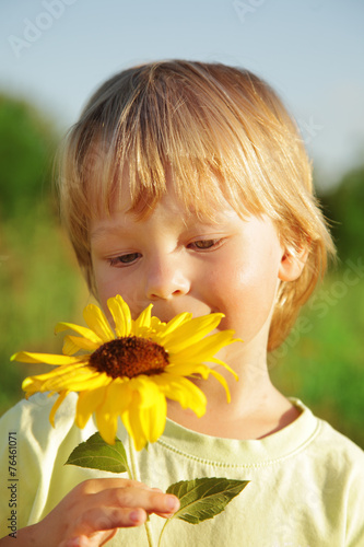 Happy boy with sunflower