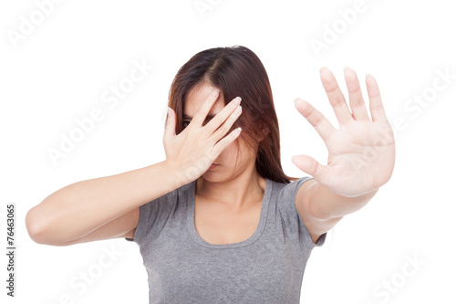 Young Asian woman hide her face with hand