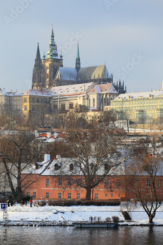 Snowy Prague gothic Castle abova River Vltava, Czech Republic photo