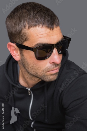 Criminal with sunglasses looking at camera