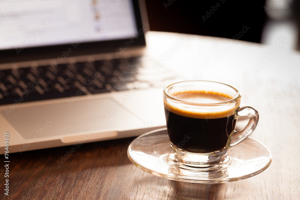 cup of espresso on a wooden background table. cup of espresso on a wooden background table.