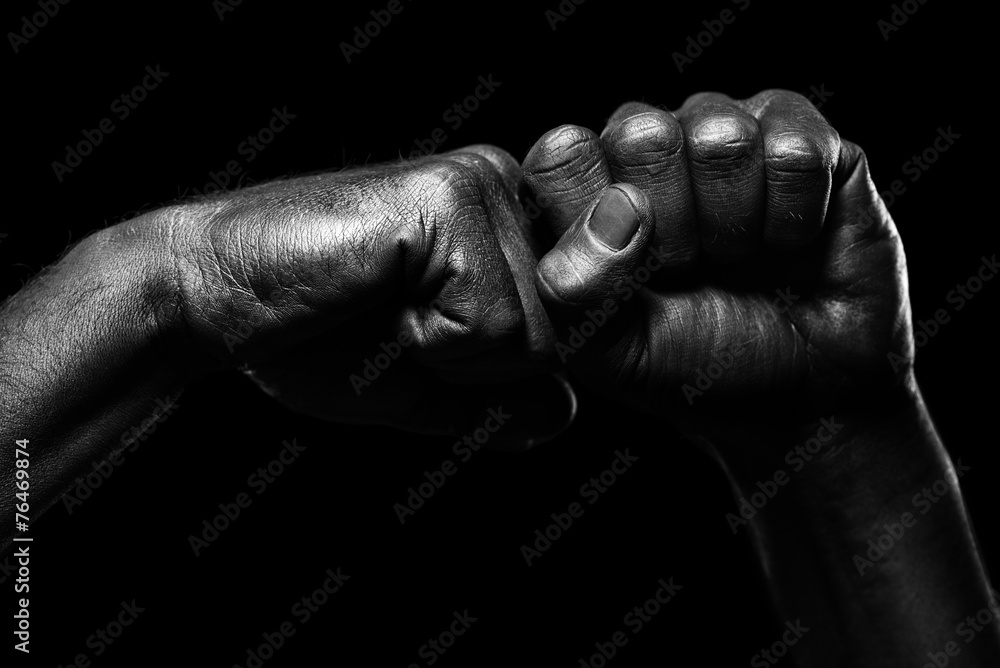 Strong male hands in black paint on black background Strong male hands in black paint on black background