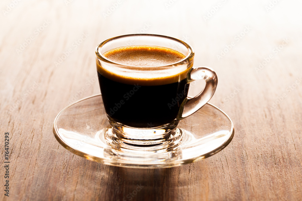 cup of espresso on a wooden background table. cup of espresso on a wooden background table.