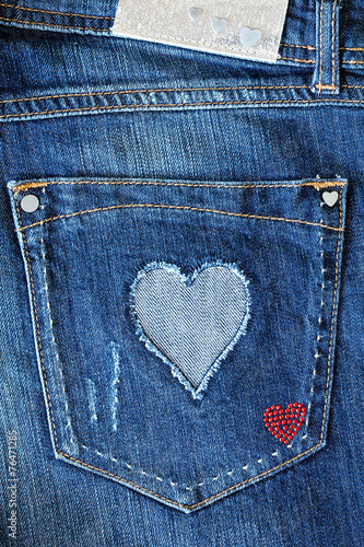 Close-up blue denim with a pocket decorated with heart.