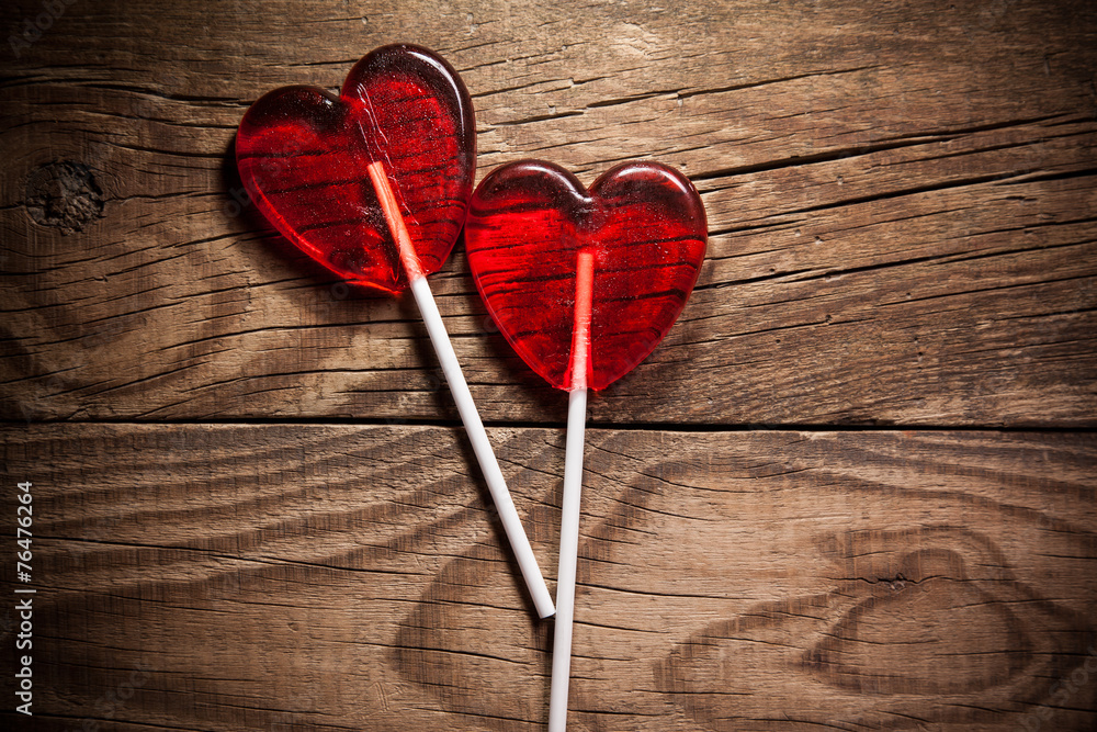 Lollipop heart on vintage wooden background - obrazy, fototapety, plakaty 