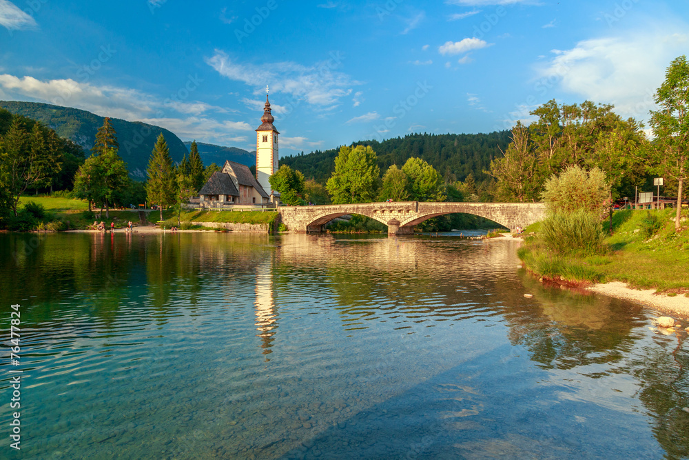 Church of Sv. John the Baptist and a bridge by the Bohinj lake Church of Sv. John the Baptist and a bridge by the Bohinj lake