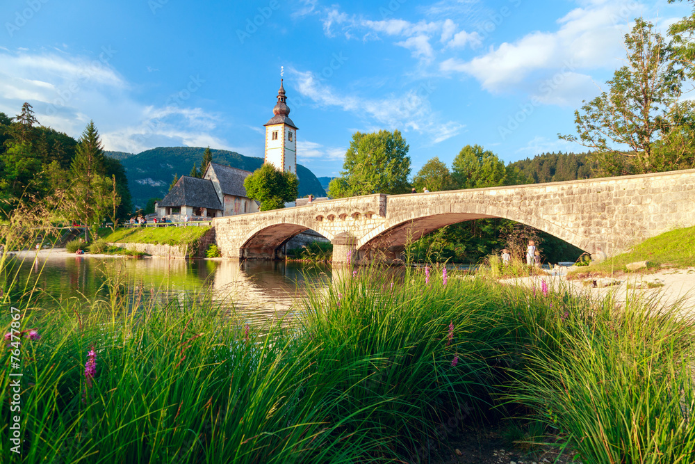 Fototapeta premium Church of Sv. John the Baptist and a bridge by the Bohinj lake